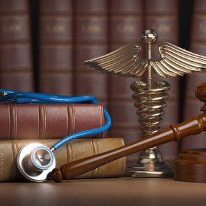 Image is of law book, gavel, and stethoscope on the desk of a Brockton bicycle accident lawyer 