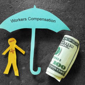 This image is of a a paper cut out of a person under a paper umbrella that represents being protected by Taunton workers compensation lawyer and insurance 